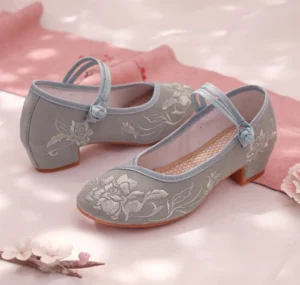 Side view of dusty blue traditional Chinese Hanfu shoes with white peony embroidery, double ankle straps, low block heel, and rubber outsole