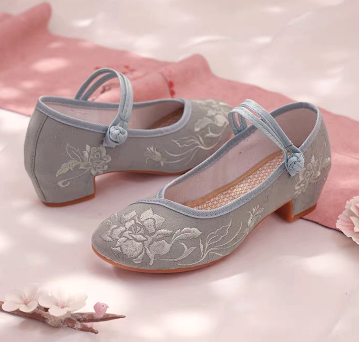 Side view of dusty blue traditional Chinese Hanfu shoes with white peony embroidery, double ankle straps, low block heel, and rubber outsole