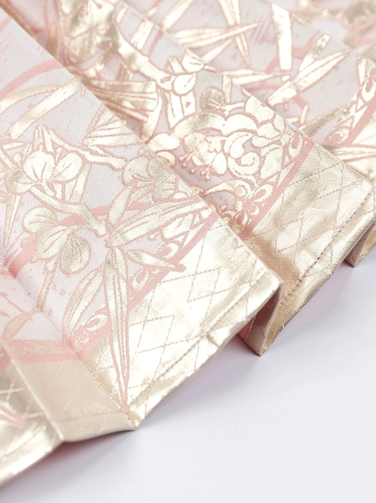 Close up of dusty pink Mamianqun horse face skirt pleats with woven floral and bamboo gold jacquard fabric