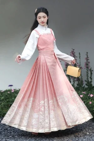 Complete dusty pink Ming style Hanfu outfit with layered top bustier and Mamianqun horse face skirt in garden