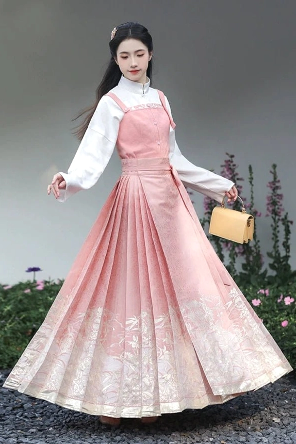 Complete dusty pink Ming style Hanfu outfit with layered top bustier and Mamianqun horse face skirt in garden