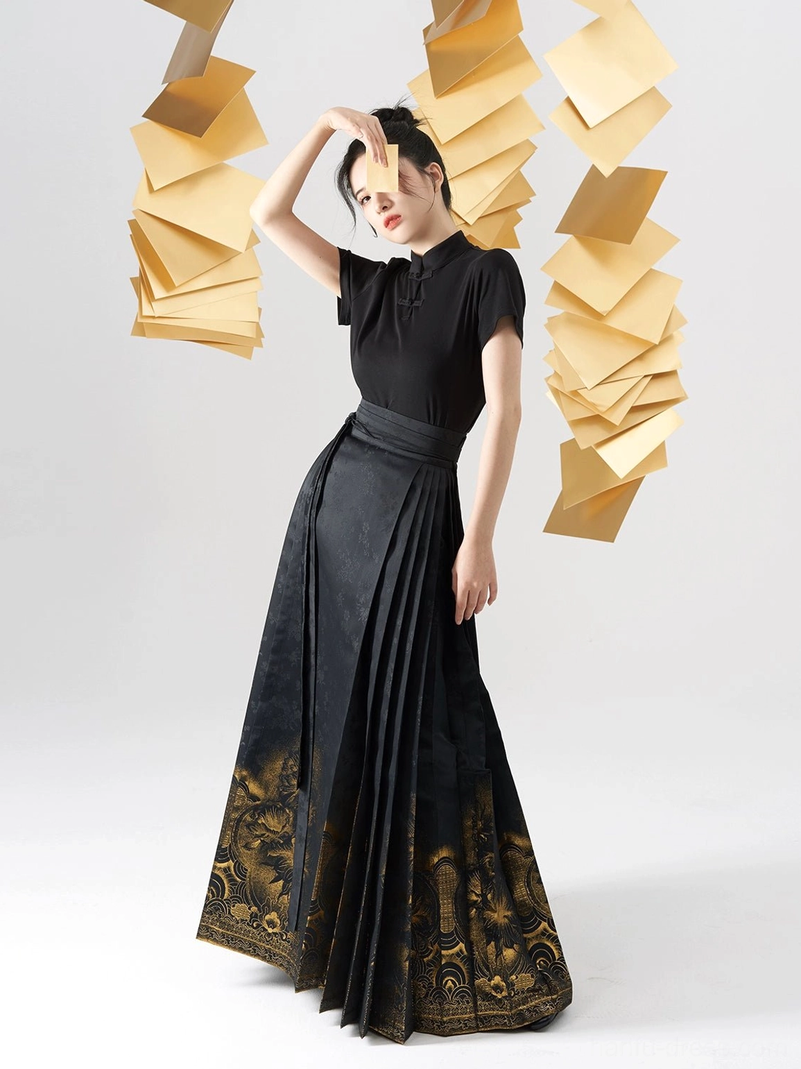 Dynamic front view of a black Ming-inspired Hanfu outfit with short-sleeve stand-collar top and golden gradient skirt pattern