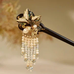 Ebony Chinese hair stick with gold-tone abalone flower ornament, pearl accents and layered pearl crystal tassels on a warm dried flower background