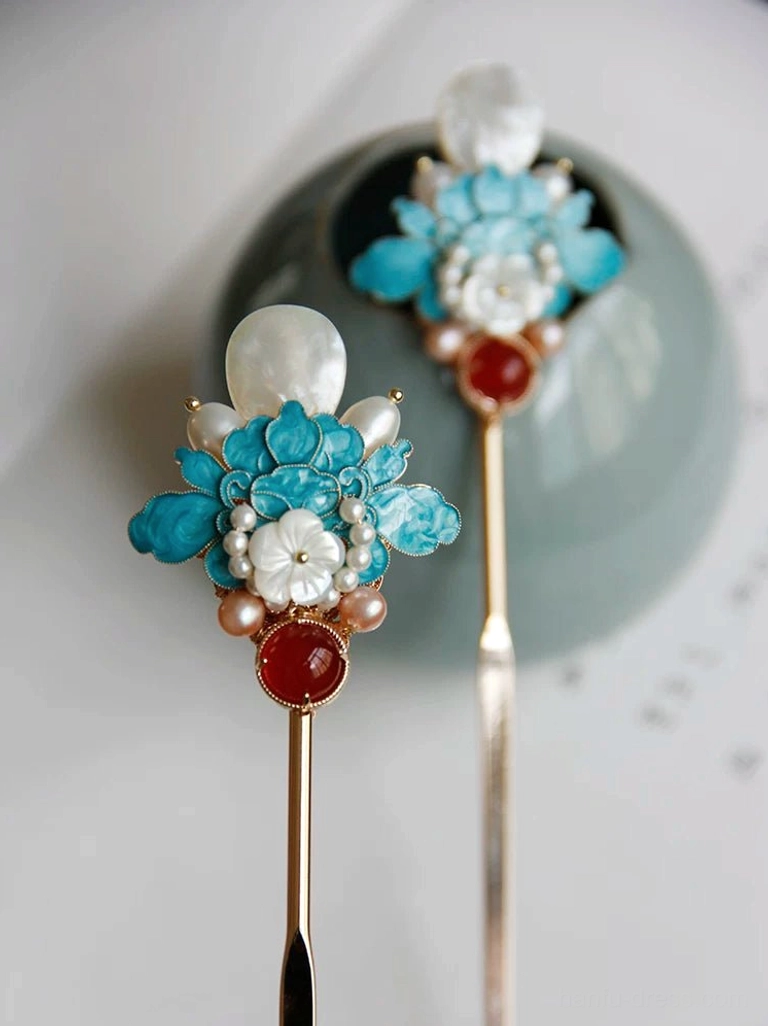 Front oblique view of elegant blue peony Chinese hair sticks with mixed metal finishes, white shell petals, freshwater pearls, and red agate accents
