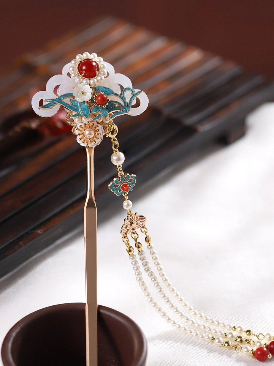 Front angled view of an elegant Chinese hair stick with layered gold chains, decorative tassel, pearl accents, and Hanfu-inspired vintage styling