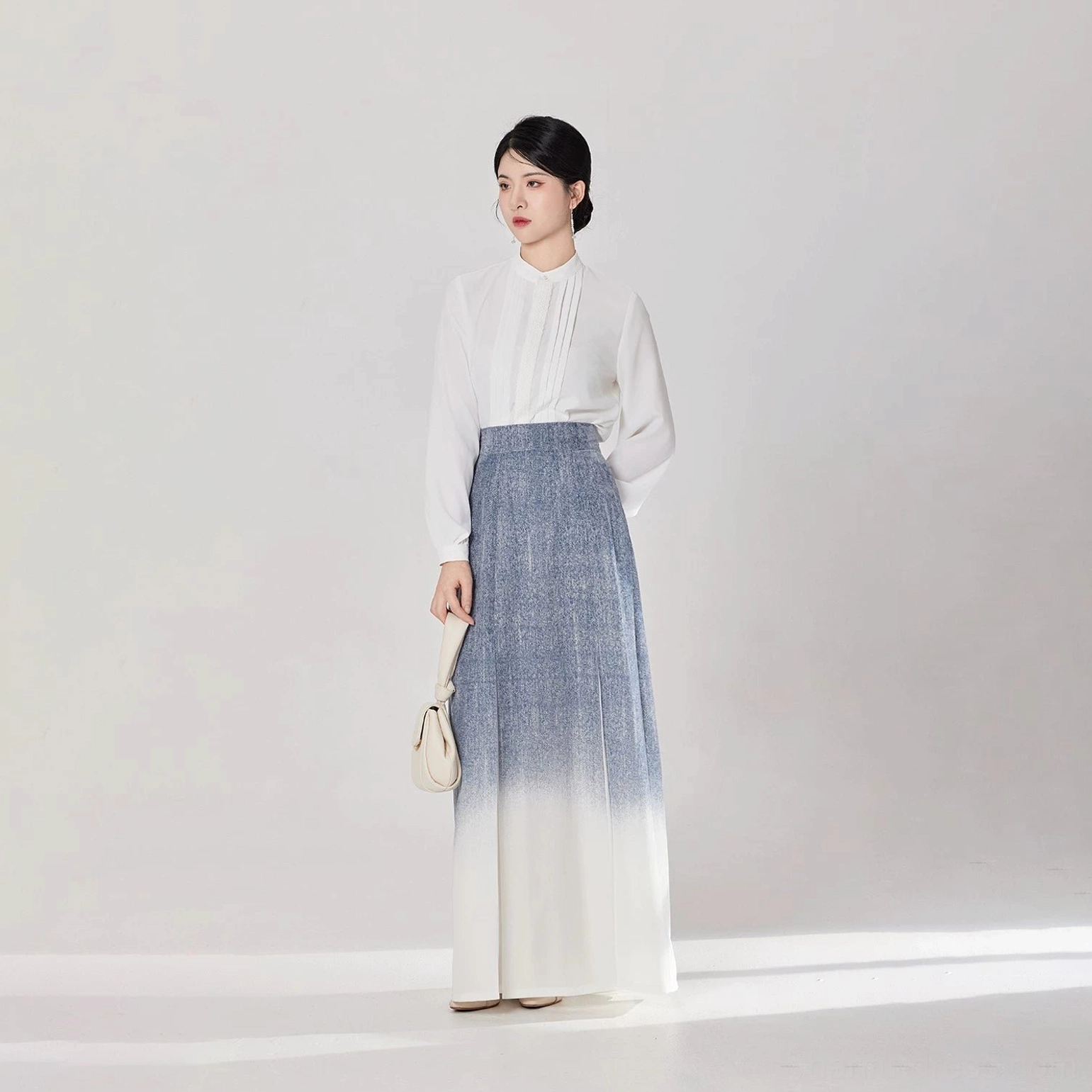Full-body front view of an elegant everyday modern Hanfu set with white stand-collar top and flowing gradient skirt