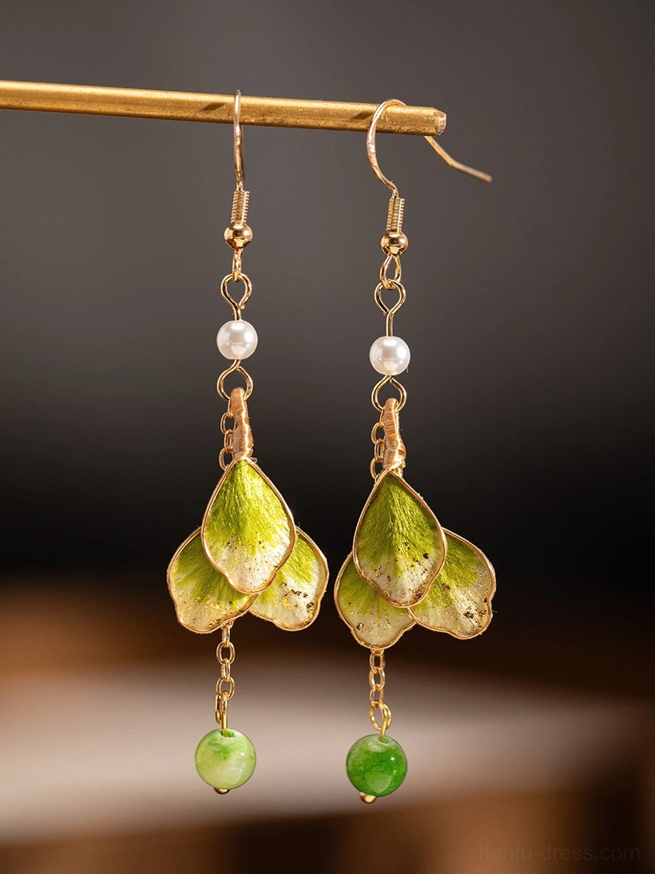 Front view of elegant green petal Chinese earrings with gold hooks, pearl accents and traditional botanical-inspired styling