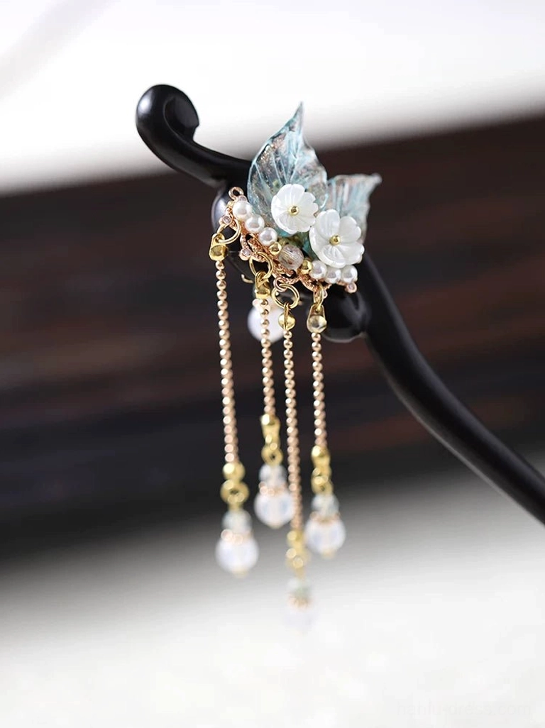 Elegant Hanfu hair stick displayed on a stand with neatly arranged gold tassel chains and uniform round bead pendants