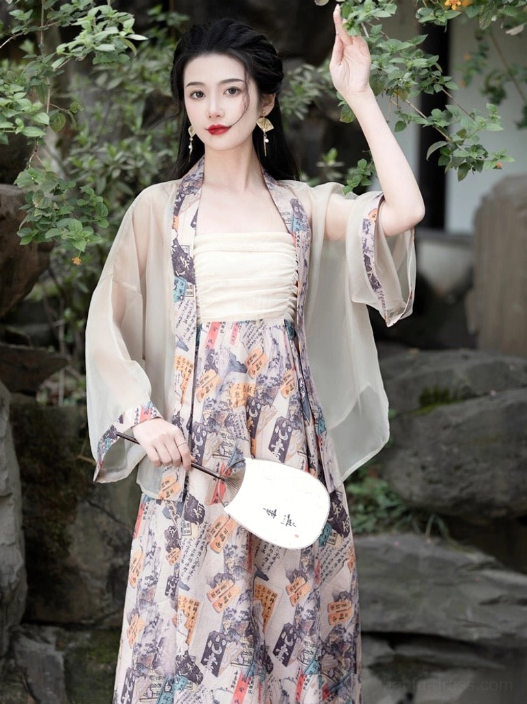 Elegant modern hanfu Tang style dress set with cream ruched camisole, sheer cardigan and long printed skirt in a Chinese garden setting