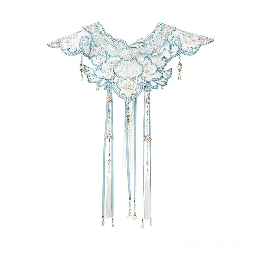 Flat lay view of an embroidered pale blue and white Chinese cloud collar with floral stitching, long tassel pendants, and decorative charms