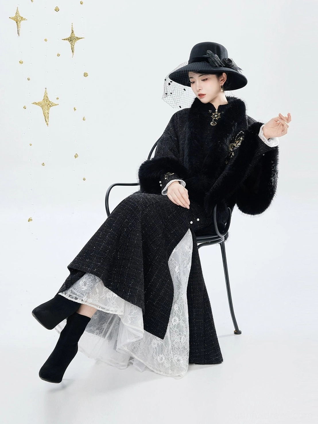 Seated view showing the lace underlayer of the black embroidered mermaid qipao dress and matching Chinese style cloak