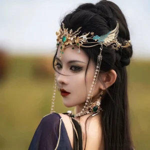 Side view of Chinese style Hanfu forehead ornament with gold tone wings, pearl tassels, matching earrings and necklace