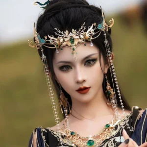 Female model wearing Emerald Shadow Hanfu headdress with emerald green stones, blue details, pearl tassels, matching necklace and earrings