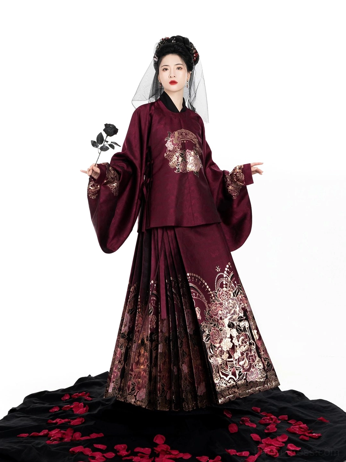 Full-length front view of the Eternal Night Rose Ming Dynasty Hanfu set in burgundy with floral details, styled with rose petals for a dramatic portrait