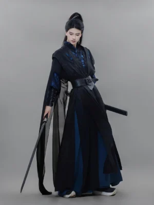 Full body side view of a male Xianxia hanfu warrior costume in black and navy blue with jacquard robe, sheer chiffon cape, and wide waist belt
