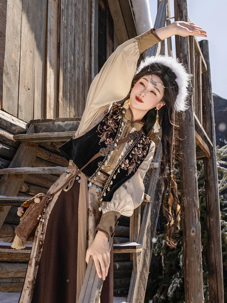 Three-quarter view of a woman wearing an ethnic style Tang Dynasty Hanfu outfit with flowing skirt woven crossbody bag and braided hair beside a wooden cabin