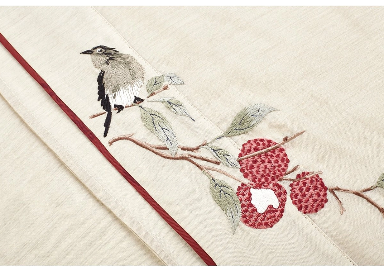 Evening Magpie Hanfu fabric detail featuring a magpie motif on a lychee branch with maroon trim and beige textured fabric