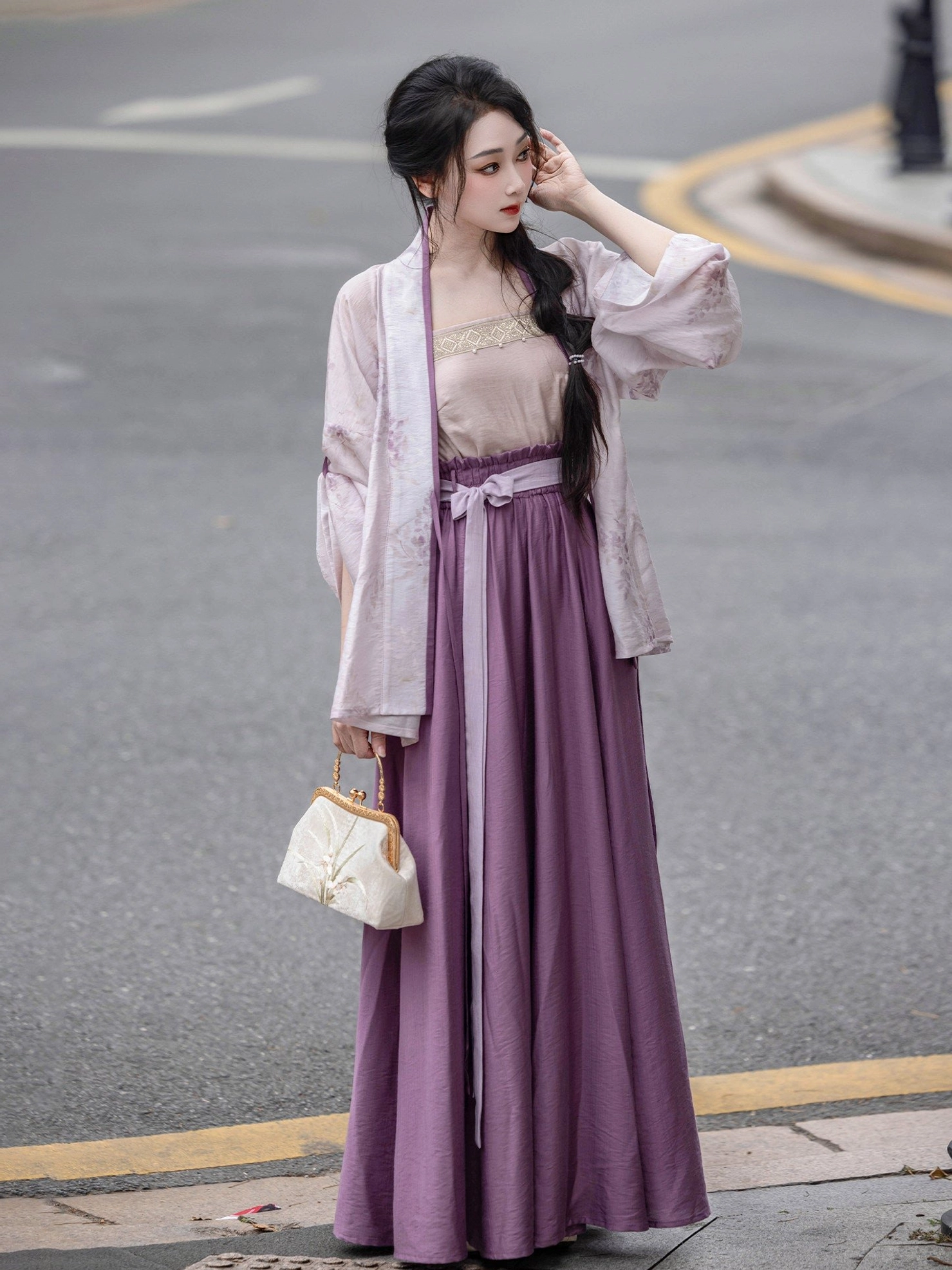 Elegant everyday Song Dynasty modern Hanfu outfit with coordinated pale purple cardigan, nude camisole, and flowing deep purple skirt worn outdoors