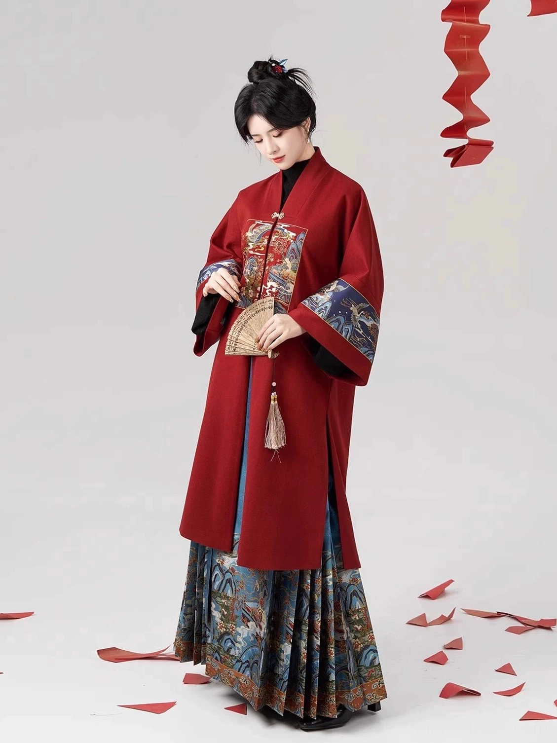 Front view of Fairy Feathers Ming Dynasty Hanfu with burgundy embroidered overcoat, blue mamian skirt, folding fan and traditional Chinese hairstyle