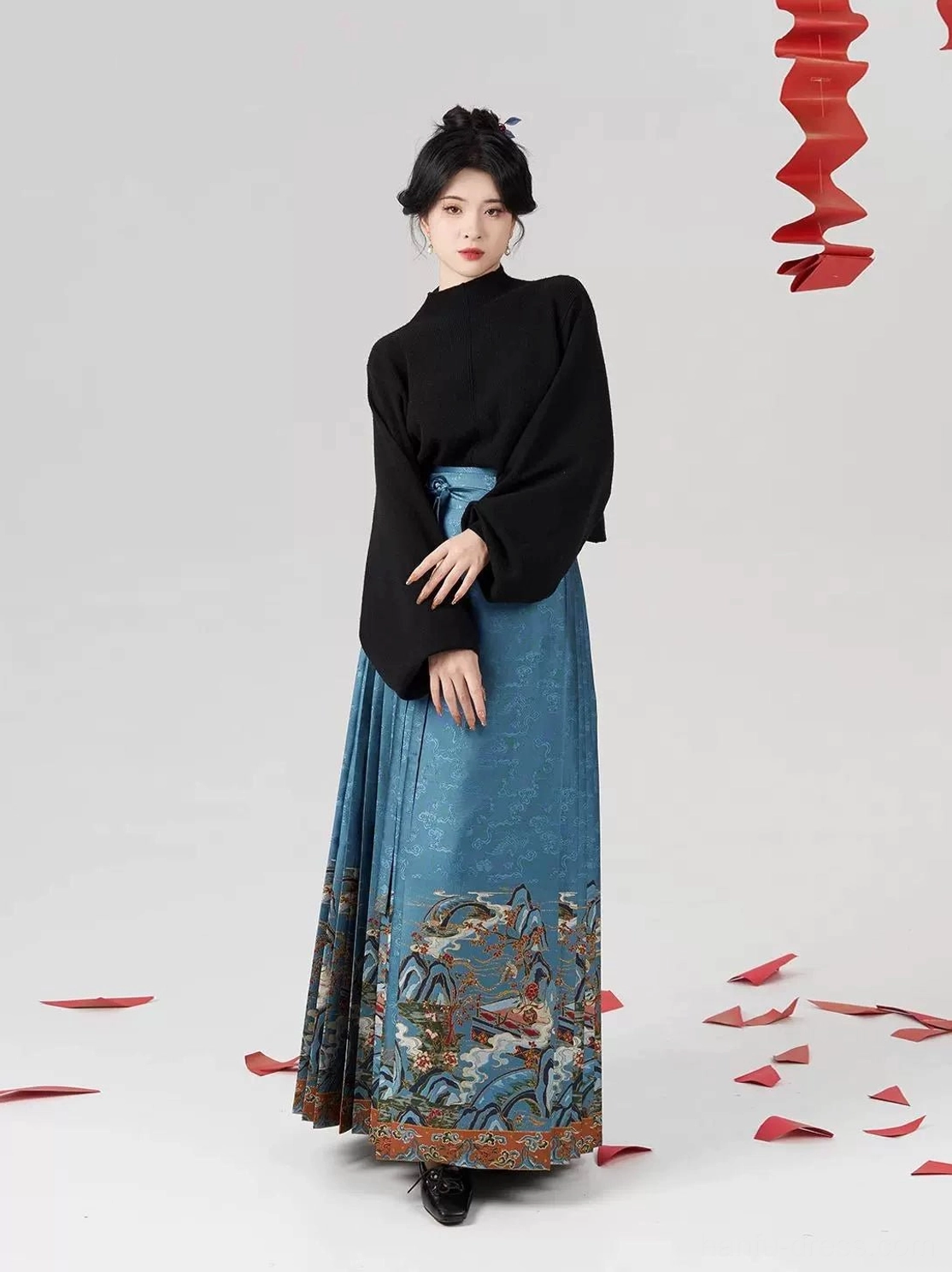 Modern Hanfu styling with black turtleneck top and dusty blue pleated Ming Dynasty mamianqun horse-face skirt, three-quarter front view