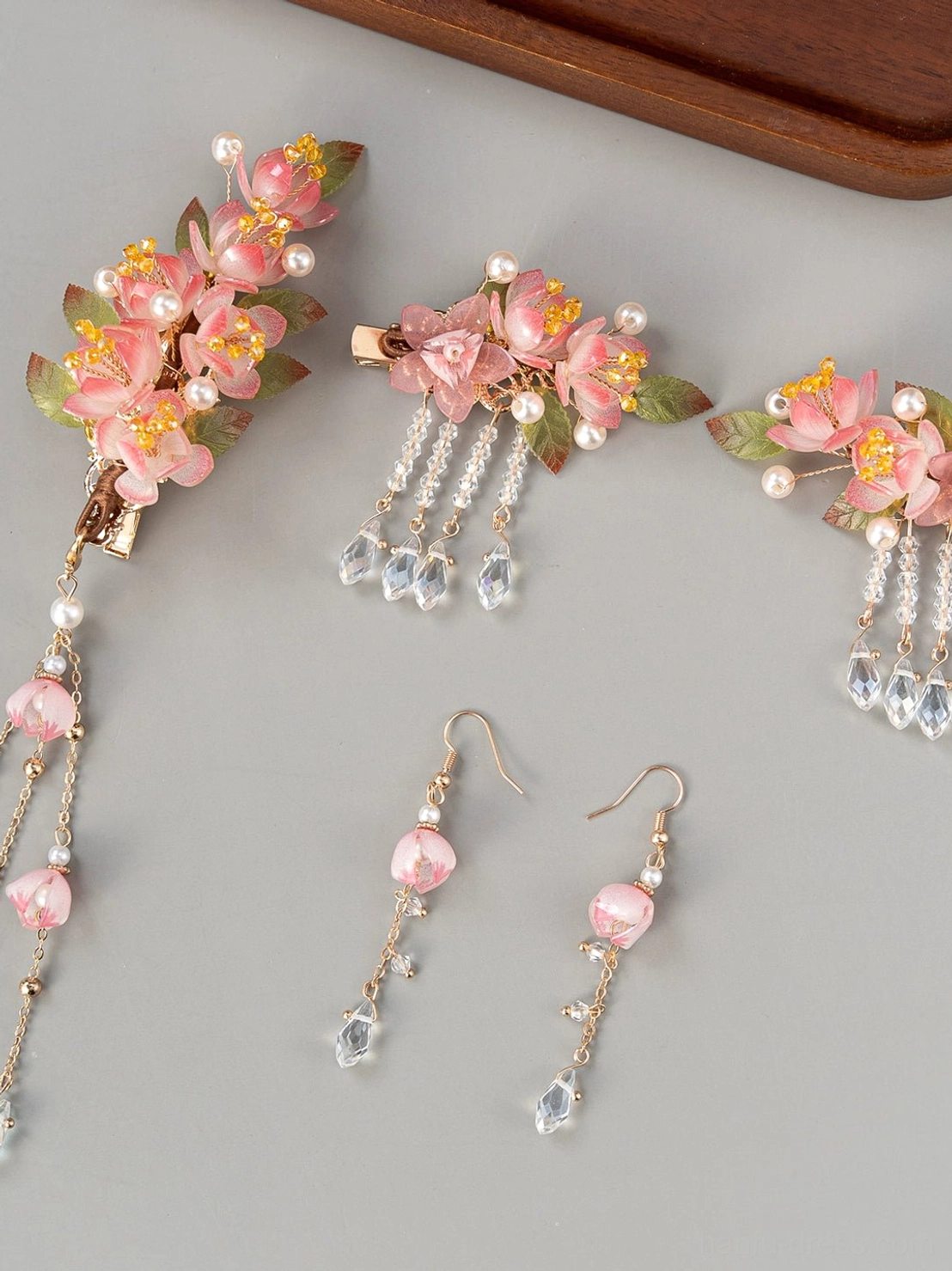 Complete pink cherry blossom Hanfu hair accessories set with flower hair clips, pearl accents, crystal tassels, pink beads, and matching dangle earrings displayed on a grey background