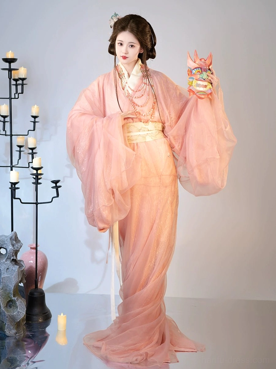 Front three-quarter view of dusty pink Han Dynasty Hanfu robe set with beige belt pearl necklaces and trailing hem