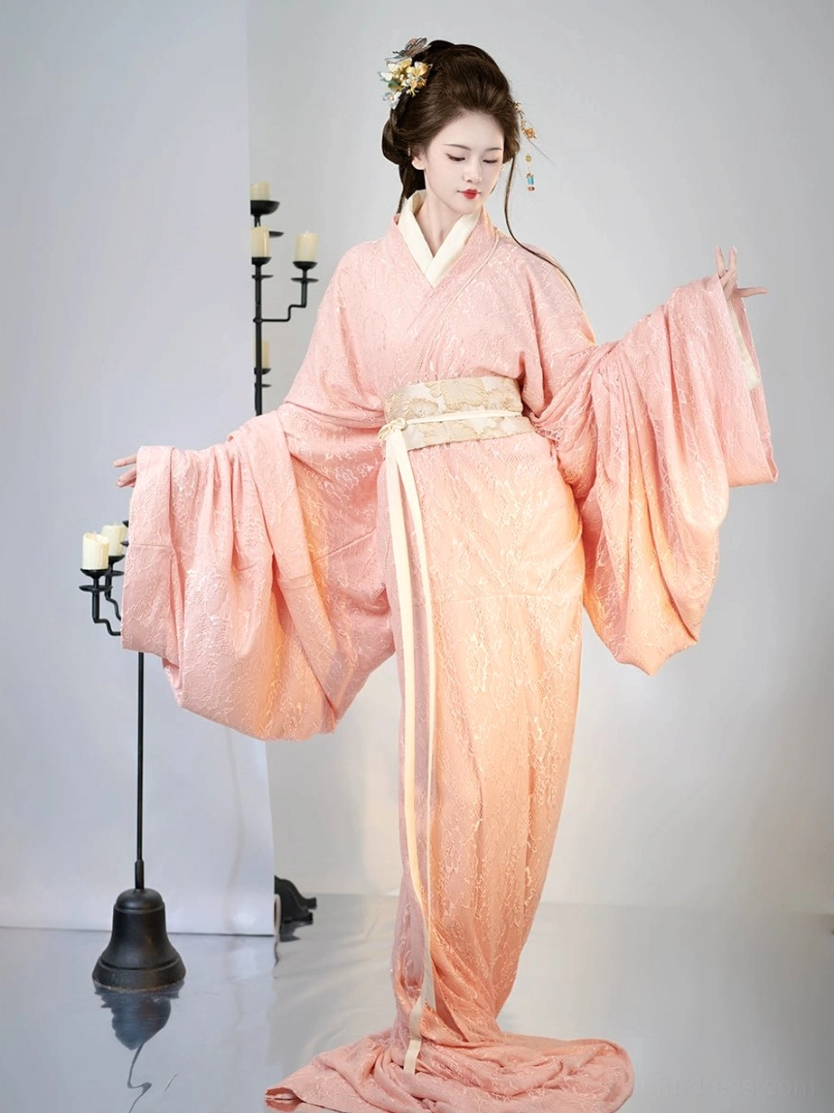 Side view of pink Han Dynasty straight hem Hanfu outfit showing cross collar beige waist sash and wide sleeves