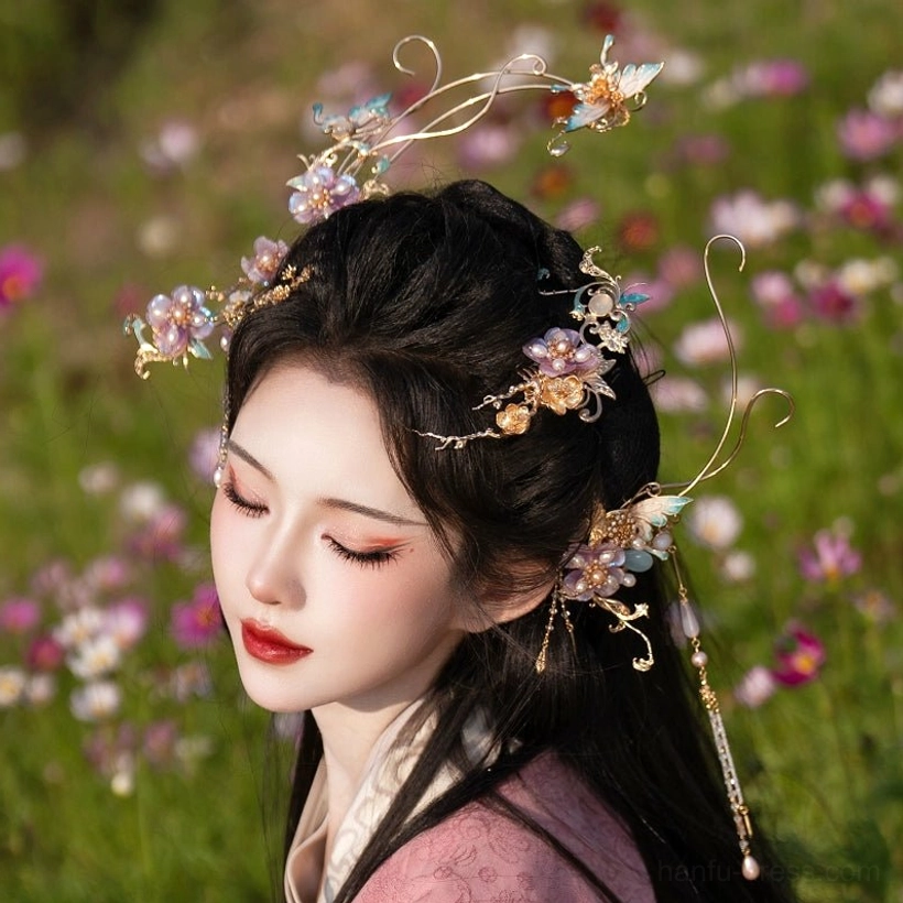 Back three-quarter portrait of a woman in pink Hanfu wearing Falling Purple Smoke hair ornaments with gold metal details, purple flowers, and beaded tassels