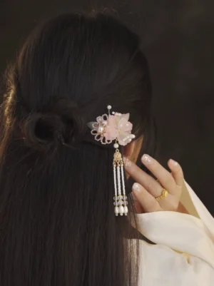 Back view of model wearing Fanghua floral pearl tassel hanfu hairpin in a half-up low bun with white hanfu