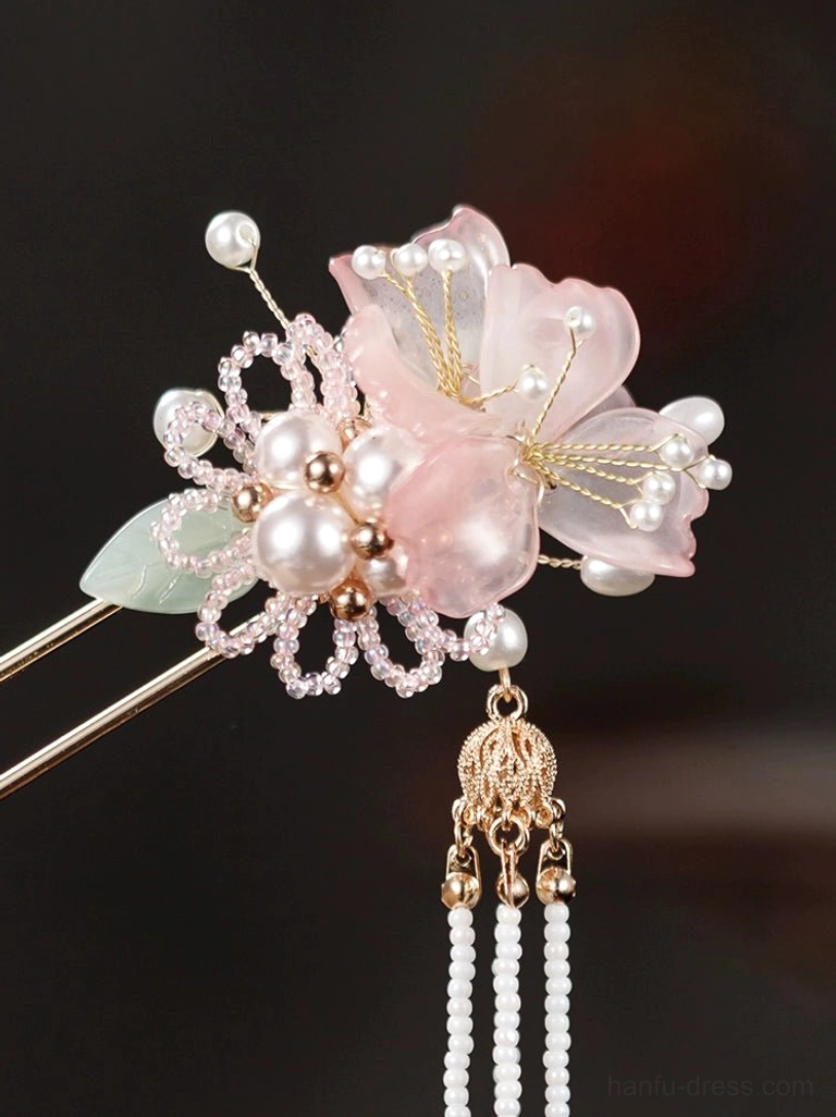 Close-up of Fanghua hanfu hairpin ornament with pink flower, green resin leaf, pearls, rhinestones and bead tassels