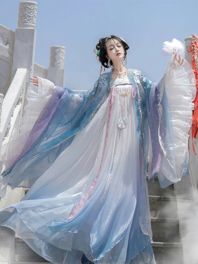 Feathered blue Tang Dynasty Qixiong Ruqun Hanfu set with gradient chiffon cloak and pink waist sash on stone stairs