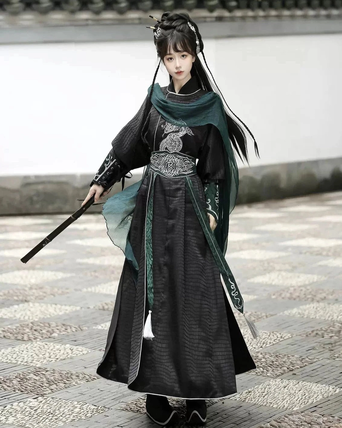 Full front view of a female xianxia warrior Hanfu outfit with black robe, white piping, dark green sashes, silver embroidery, and traditional sword styling