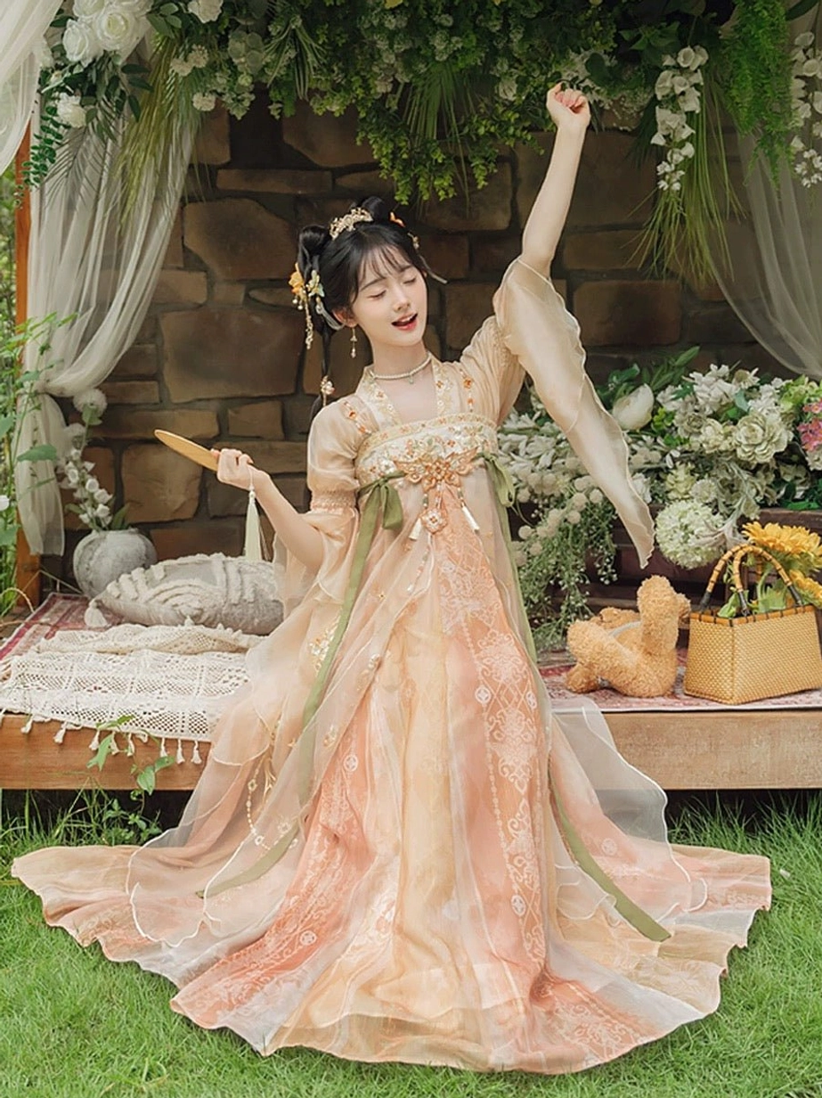 Full front dancing view of Feng Hua Chuan Xin modern Hanfu dress with sweeping skirt train, natural peach gradient, ruffled sleeve trims, and flowing Tang-inspired silhouette