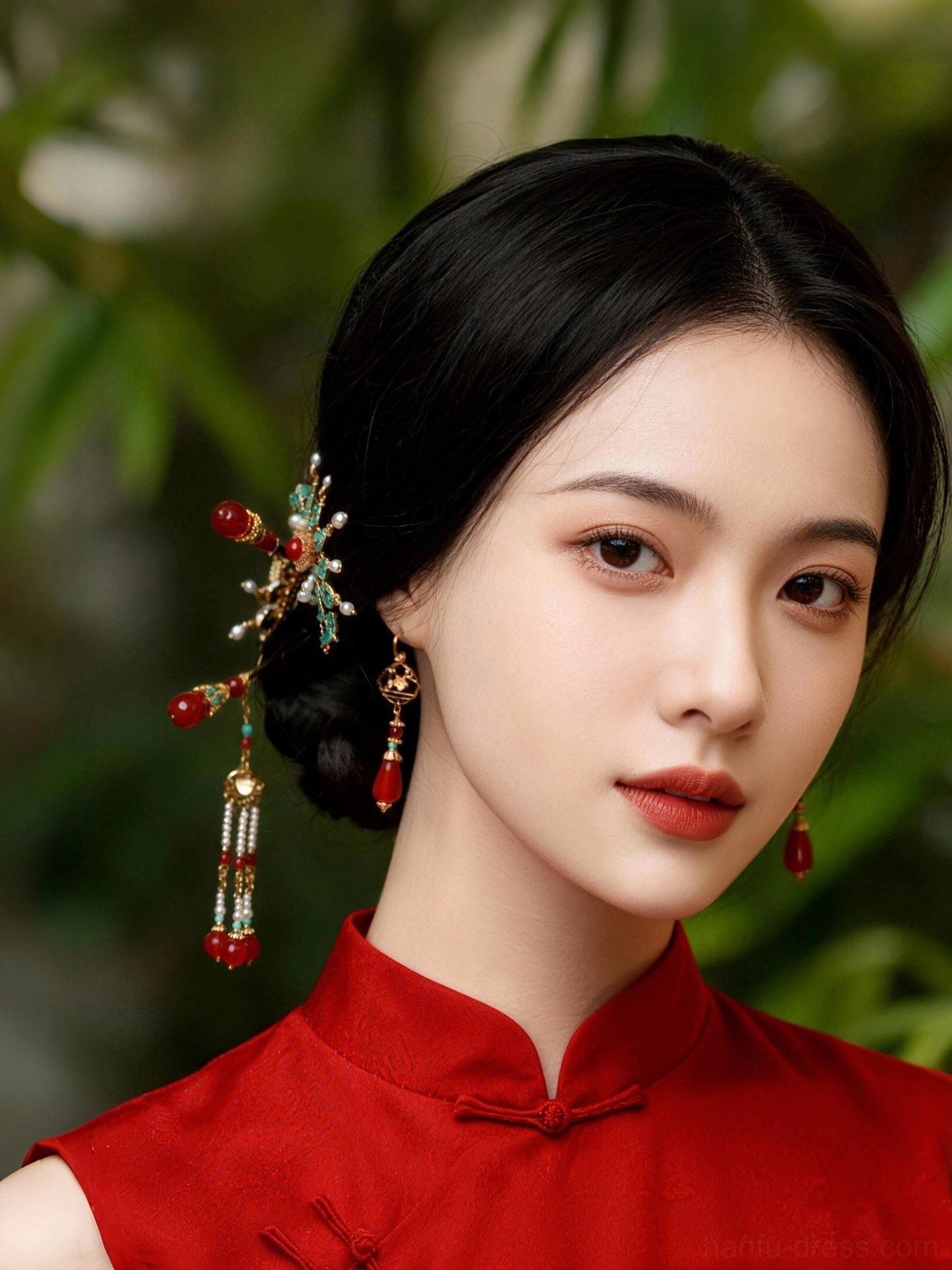 Model wearing festive red agate Chinese drop earrings with a red Cheongsam traditional outfit outdoors