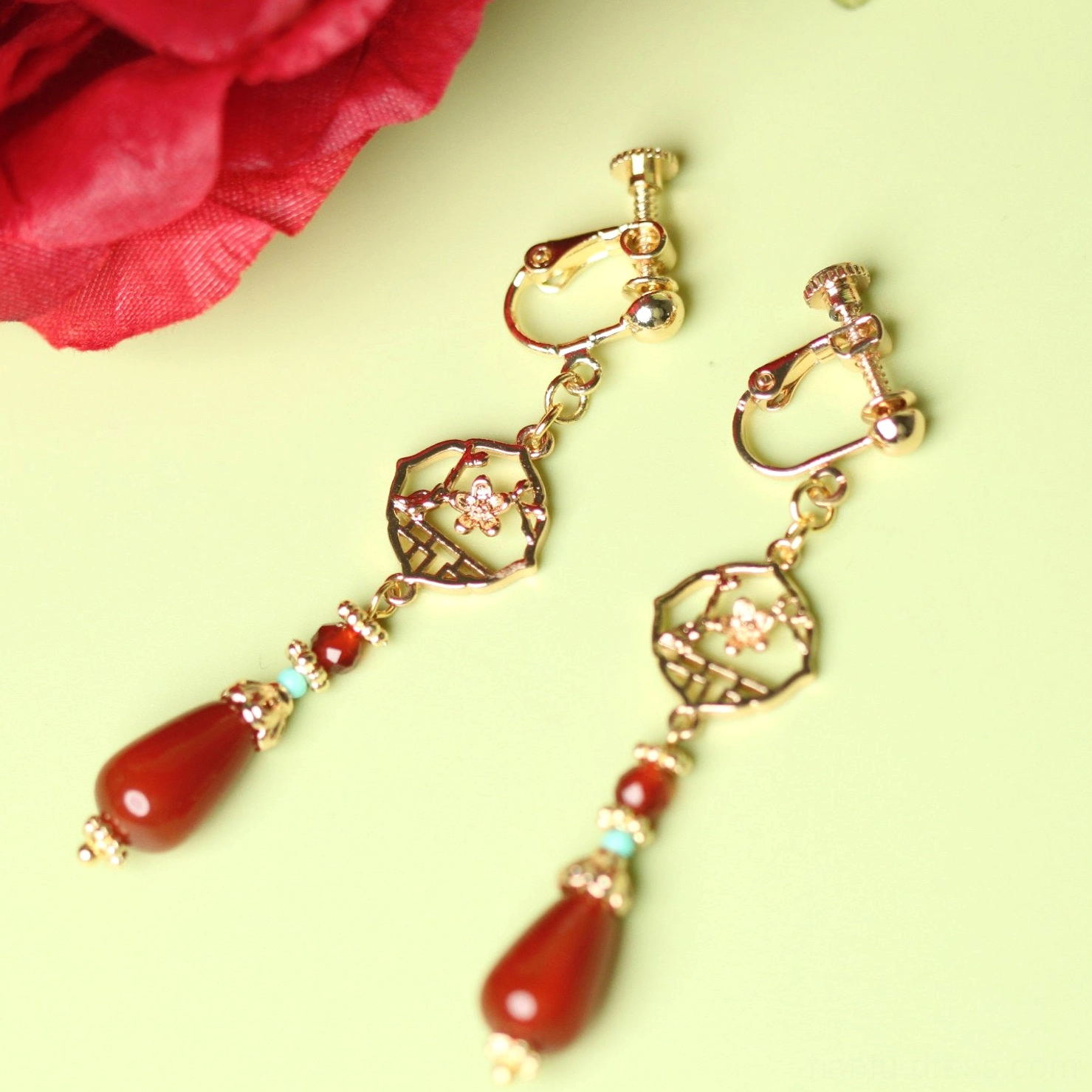 Side view of comfort clip-on red agate Chinese earrings showing non-pierced ear clip fastening detail