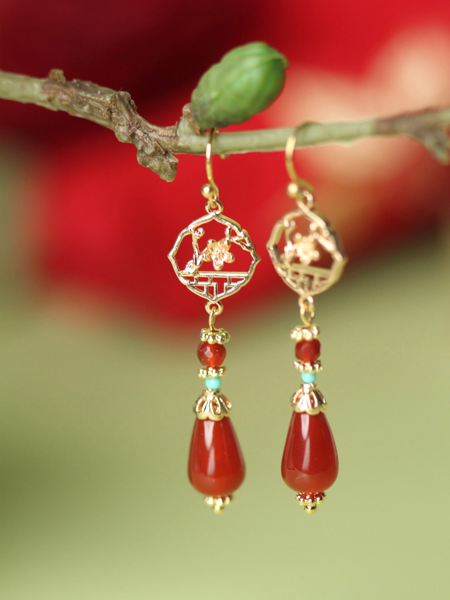 Festive red agate Chinese Hanfu drop earrings with gilded lattice flower pendant hanging on a branch