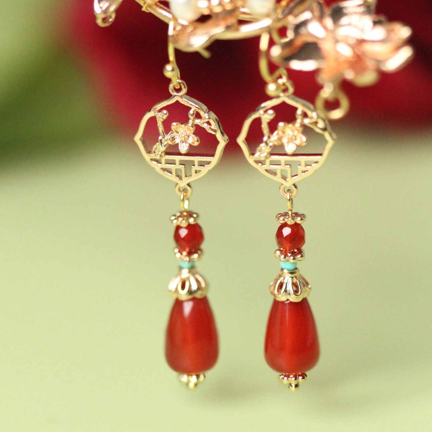 Hook closure festive red agate Chinese Hanfu earrings showing full gold lattice flower and teardrop design