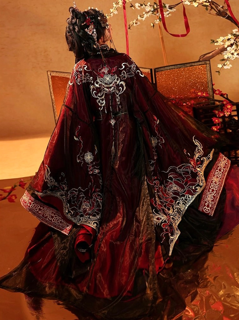 Back view of Fire Lotus Warring States Han Dynasty wedding hanfu showing large gold embroidery on deep red robe and wide flowing train