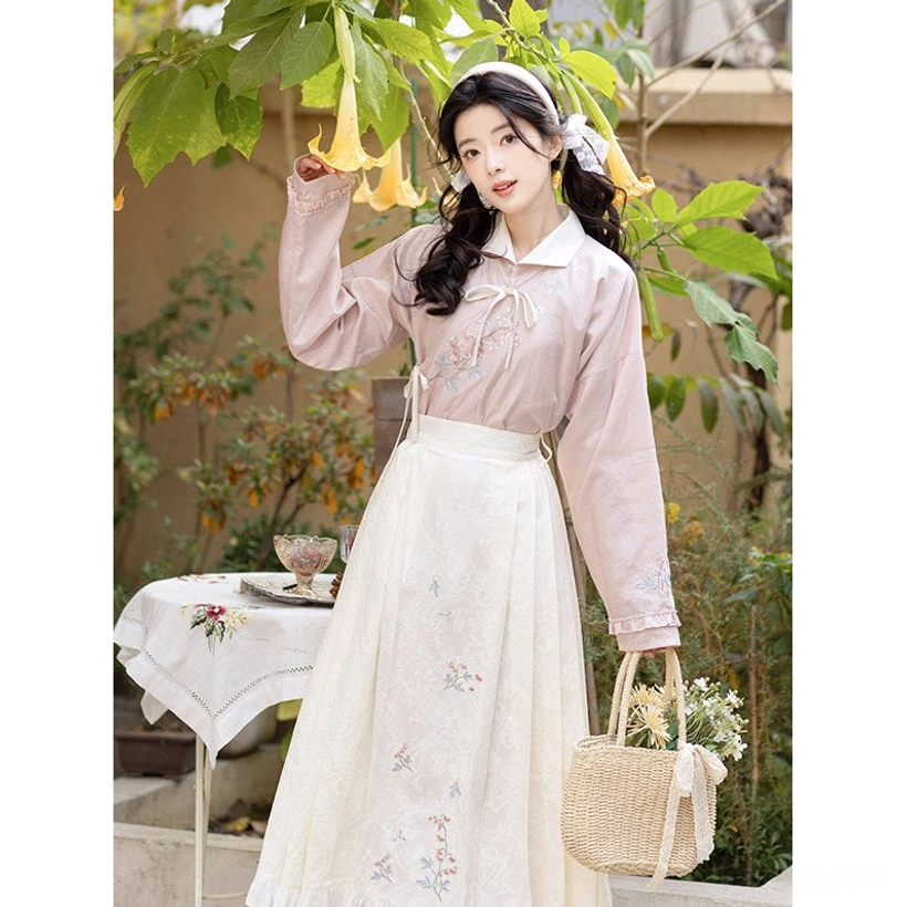 Full body garden portrait of Fish and Peony Ming-inspired hanfu set with pink embroidered top and ivory mamian skirt