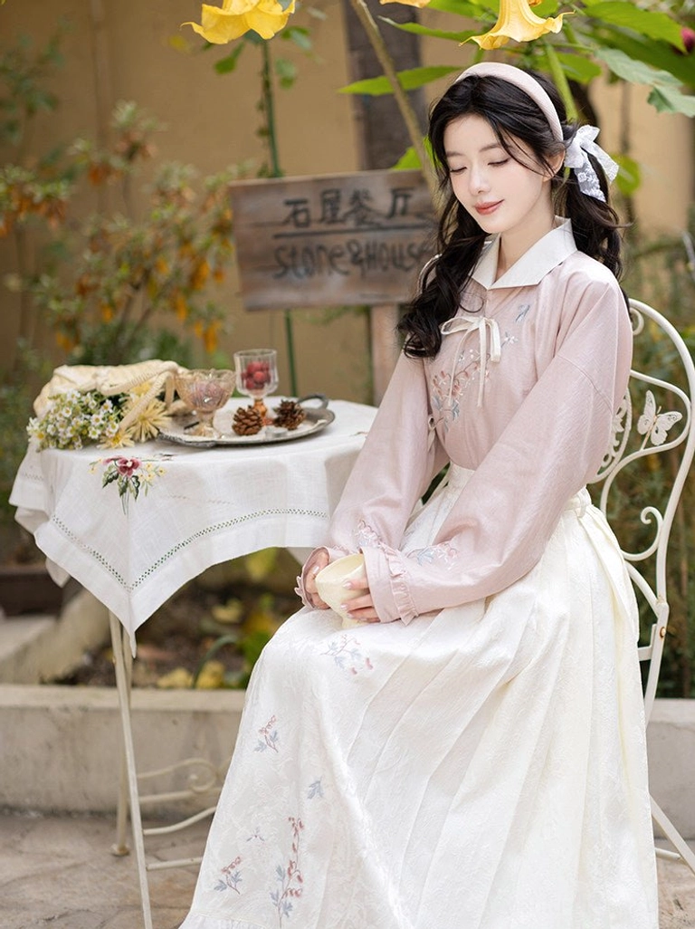 Front view of fish and peony hanfu outfit with embroidered pink shirt and pleated ivory mamianqun skirt