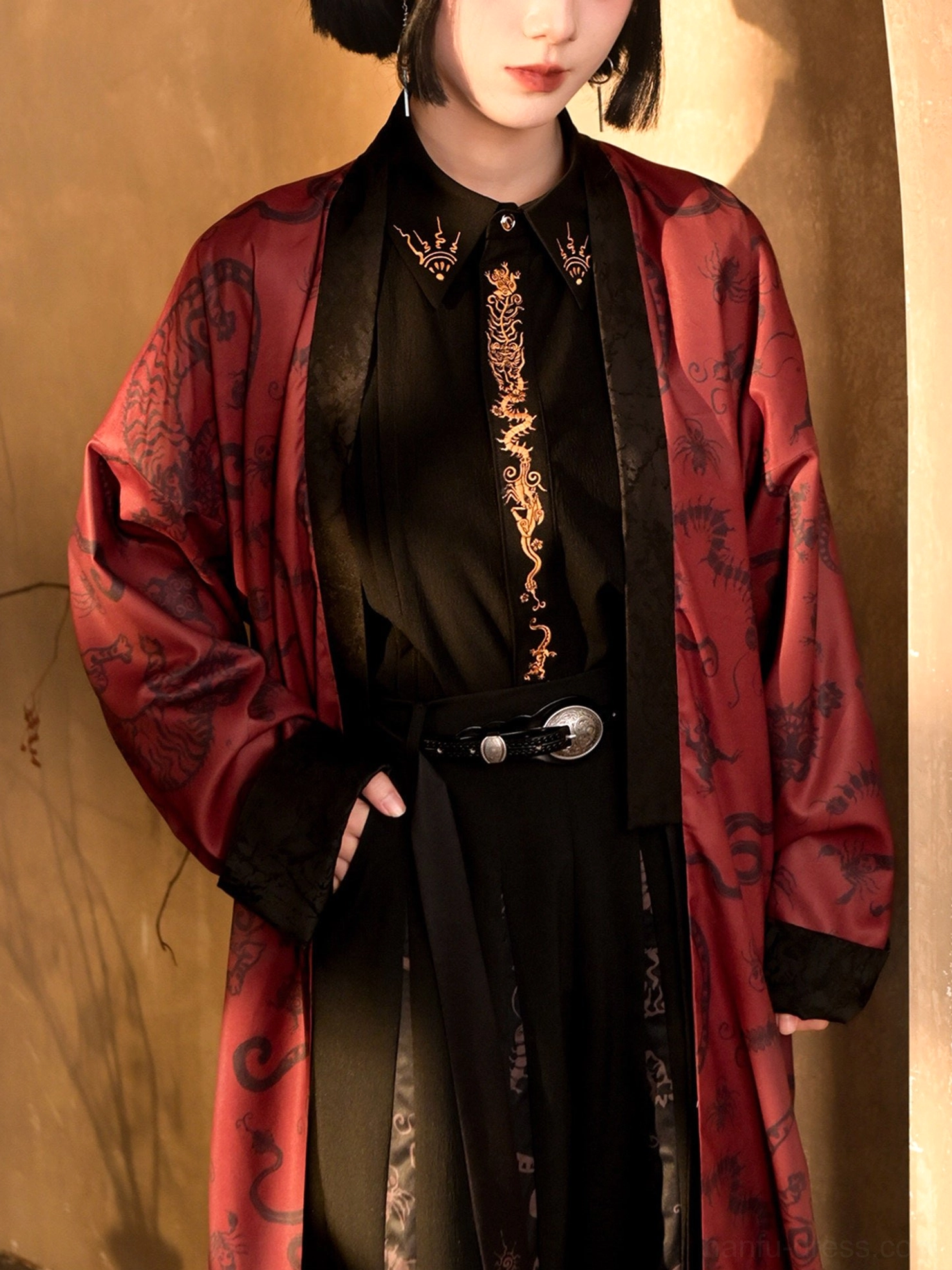 Black and gold dragon embroidered modern Hanfu long sleeve top layered under a red traditional pattern coat with silver buckle belt styling