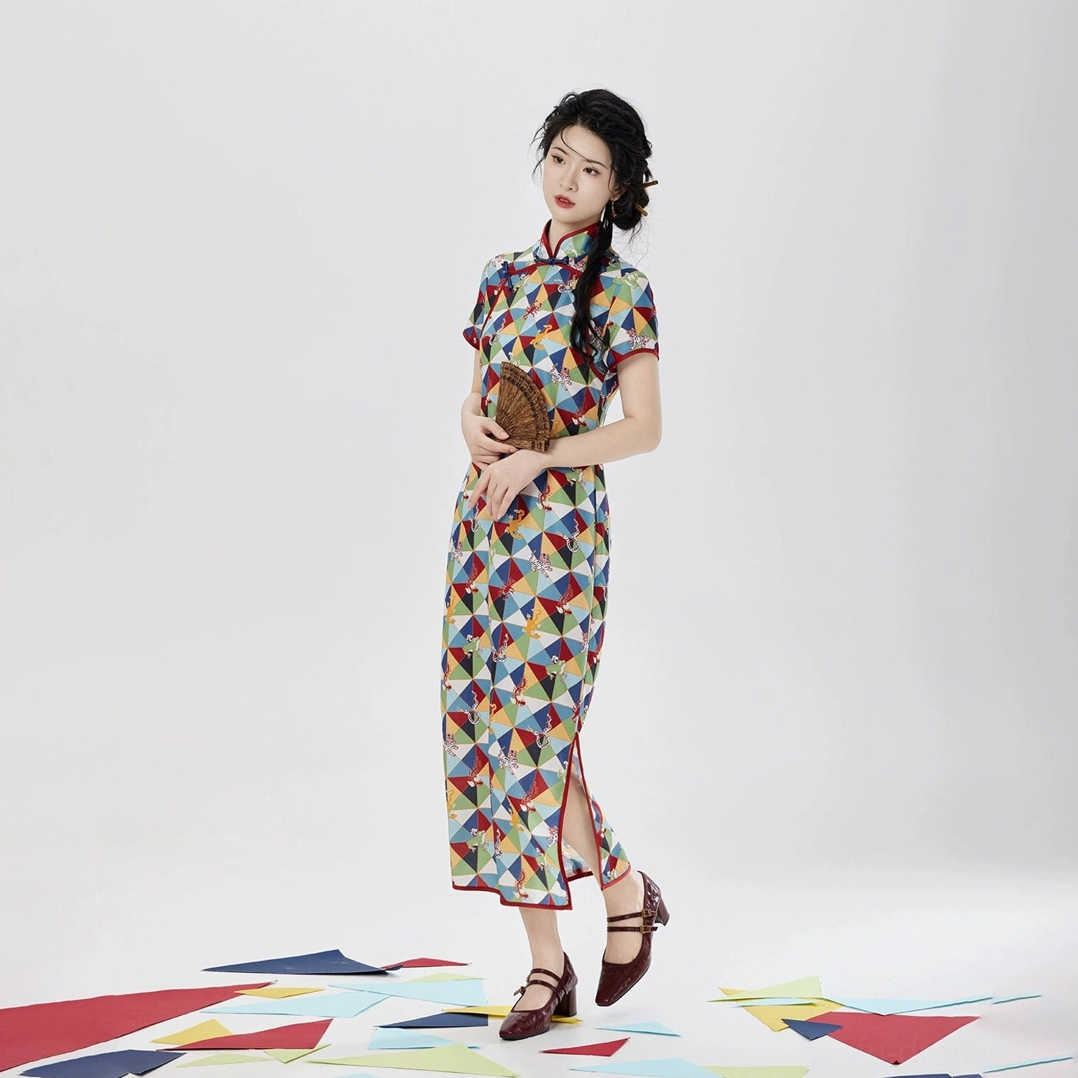 Full-body three-quarter view of Five Poisons modern Hanfu short sleeve qipao dress with red trim, colorful print, side slit, and retro styling
