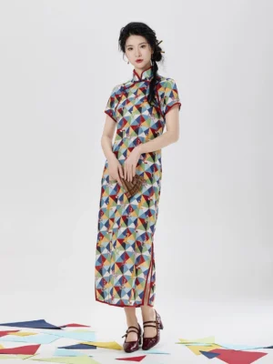 Full front view of Five Poisons short sleeve cheongsam dress with colorful geometric print, red piping, stand collar, folding fan, and side slit