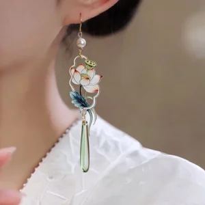 Floating lotus dangle earrings with enamel flower green leaves pearl accent and long green pendant worn with white Hanfu outfit