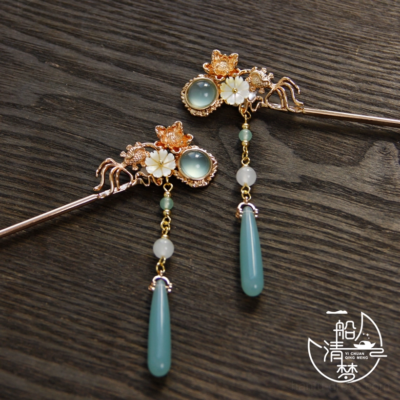 Floral Chinese hair pin set displayed apart, showing full pale blue teardrop pendants and white shell petal ornament details