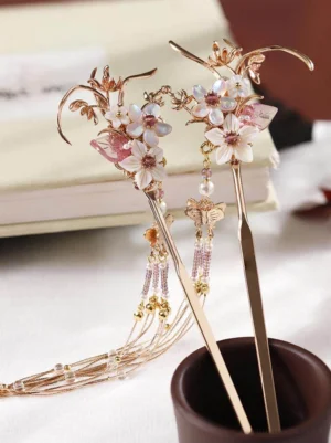 Pair of floral Chinese hair sticks with pink flowers, pearl beads, gold-toned metal details, butterfly charm, and long tassels for Hanfu hairstyles