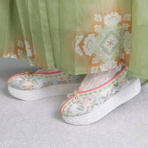 Women's light gray floral embroidered Hanfu platform shoes with pink trim, jeweled toe decoration, white sole, green pleated Hanfu skirt, and lace socks