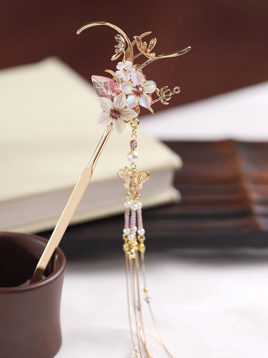 Side view of a floral Hanfu hair stick with polished gold-toned rod, decorative flowers, beads, and elegant hanging tassel