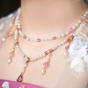 Flower fairy double layer Chinese necklace worn with embroidered Hanfu, featuring freshwater pearls, pink purple crystal beads, white flower charms and teardrop pendants