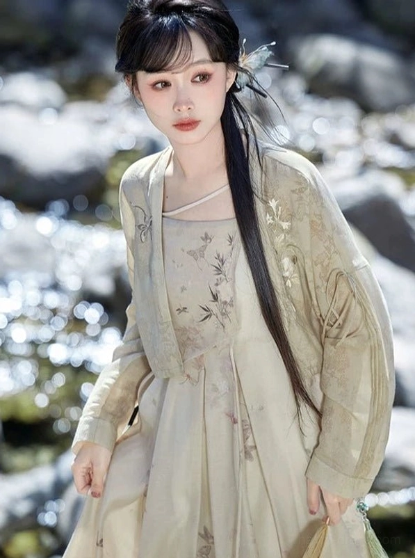 Portrait of model wearing Flower Paper apricot floral and bamboo print Tang Dynasty inspired modern Hanfu complete set